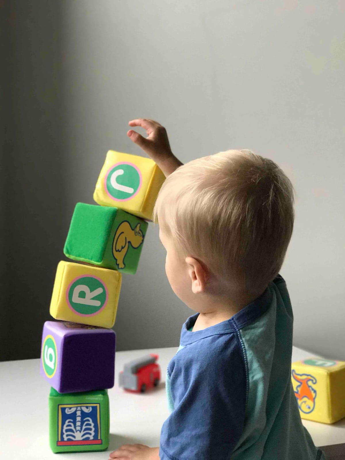 In-home respite caregiver playing with young child in Orange County